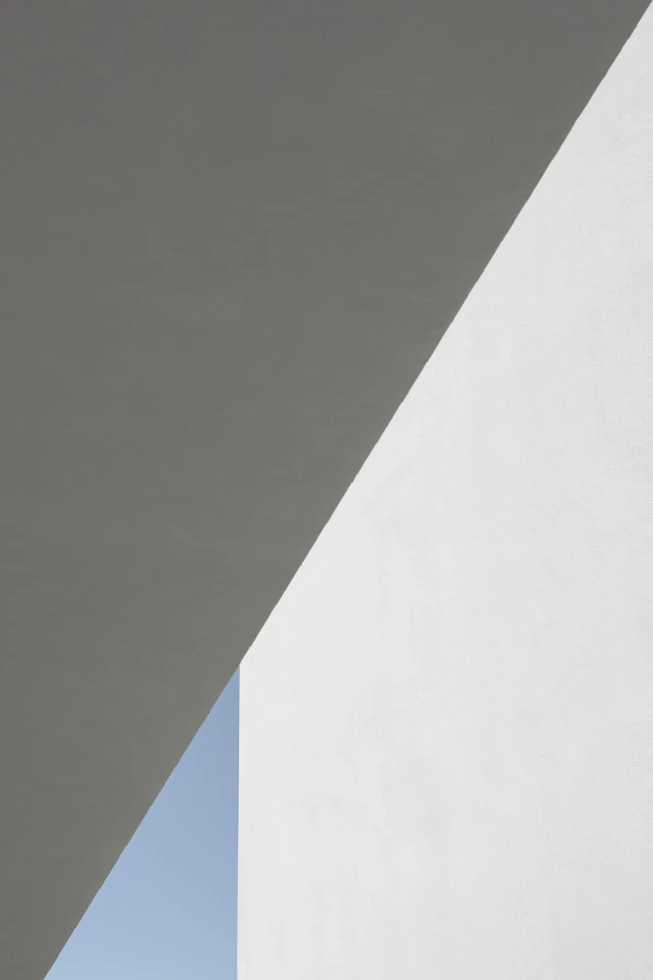 Grey and white walls meeting at a sharp diagonal