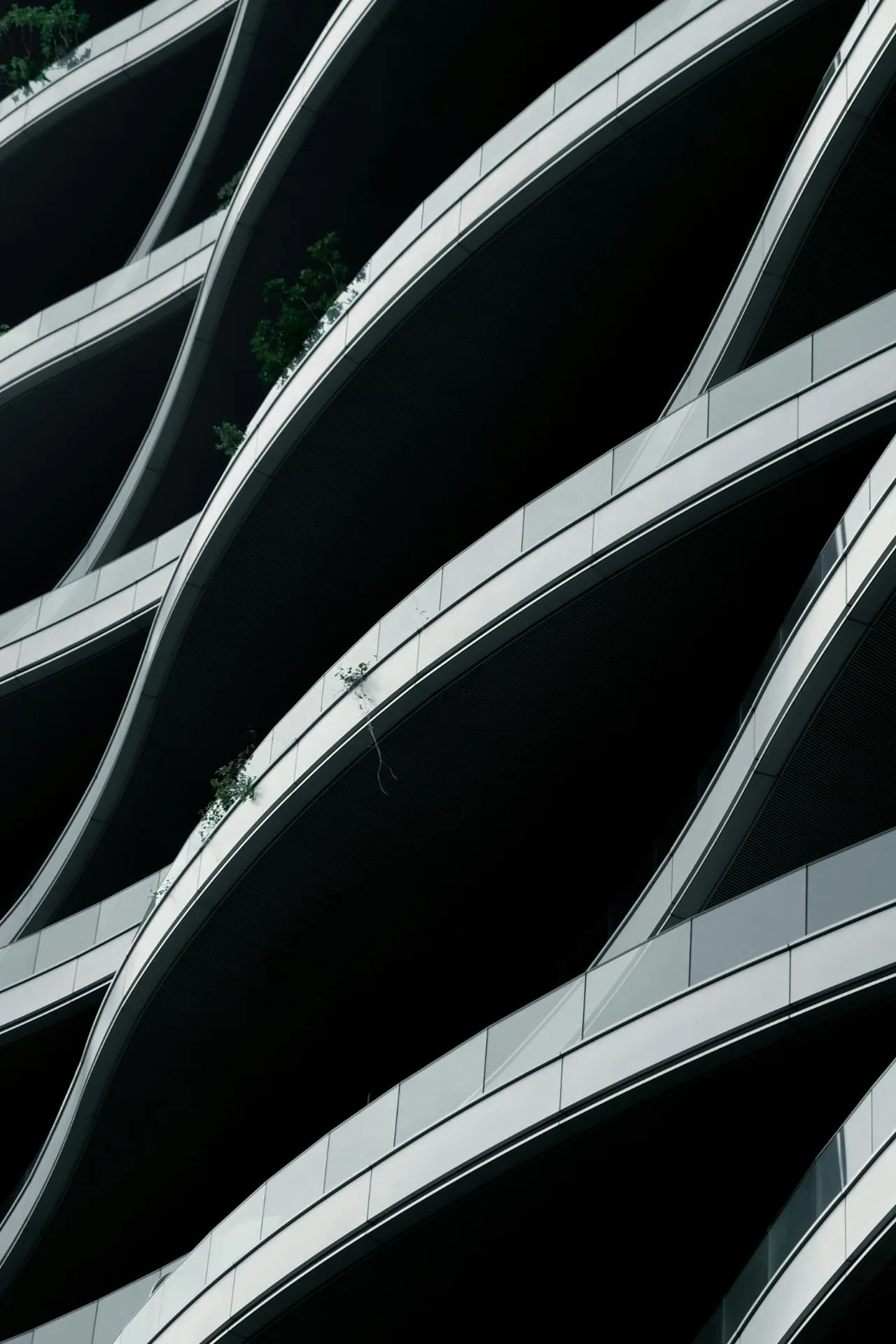 Curved black and white balconies on a modern façade