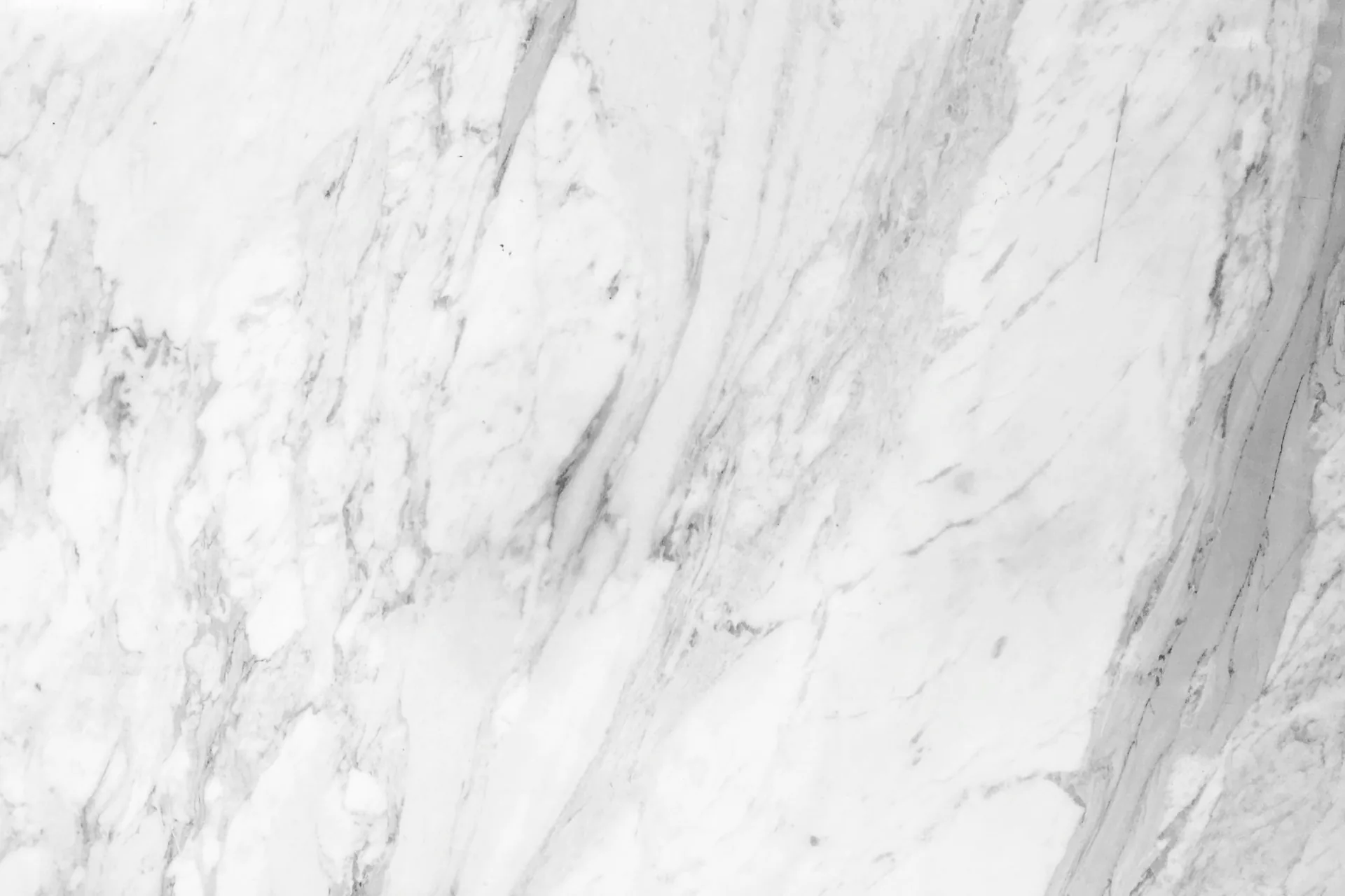 Soft grey veins running through white marble